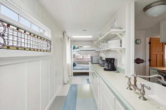 bathroom featuring plenty of natural light, sink, and a skylight