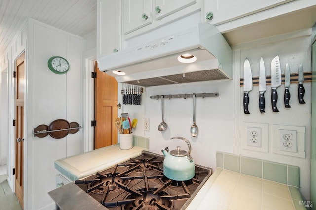 kitchen featuring white cabinetry, tile countertops, and gas cooktop