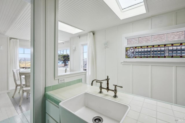 bathroom featuring sink, a wealth of natural light, and a skylight