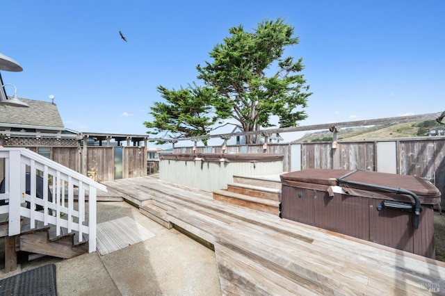 wooden deck featuring a hot tub