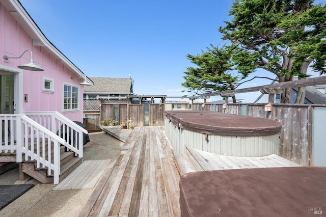 wooden terrace with a hot tub