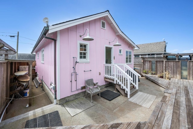 back of house featuring a wooden deck