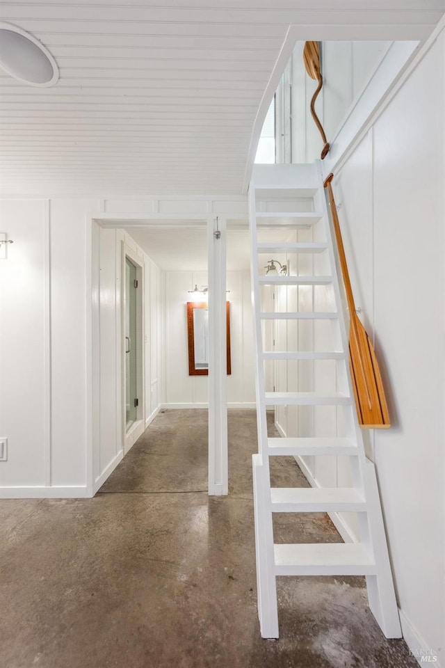 staircase with concrete floors