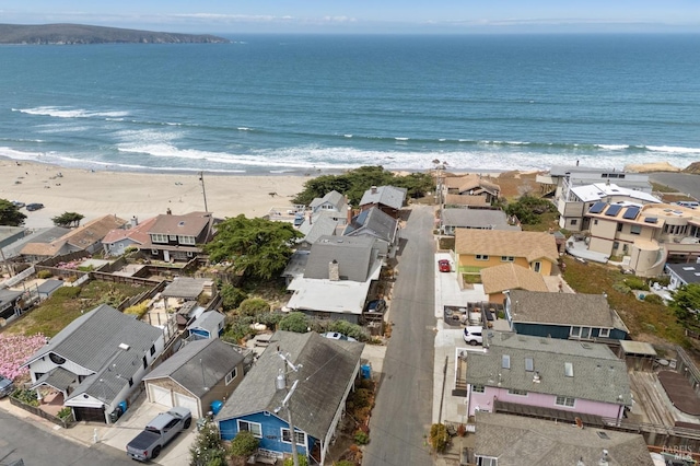 birds eye view of property with a water view and a view of the beach