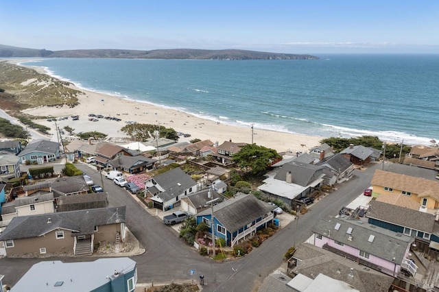 drone / aerial view with a beach view and a water view