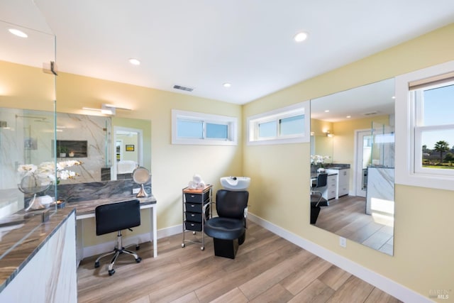 home office featuring a premium fireplace and light hardwood / wood-style flooring