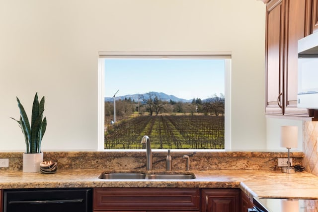 kitchen featuring sink, a mountain view, and dishwasher