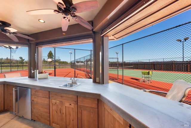 view of patio / terrace with basketball court, tennis court, ceiling fan, and an outdoor wet bar