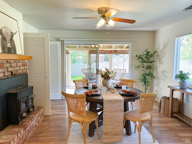 dining room with a wealth of natural light, light wood-type flooring, and visible vents