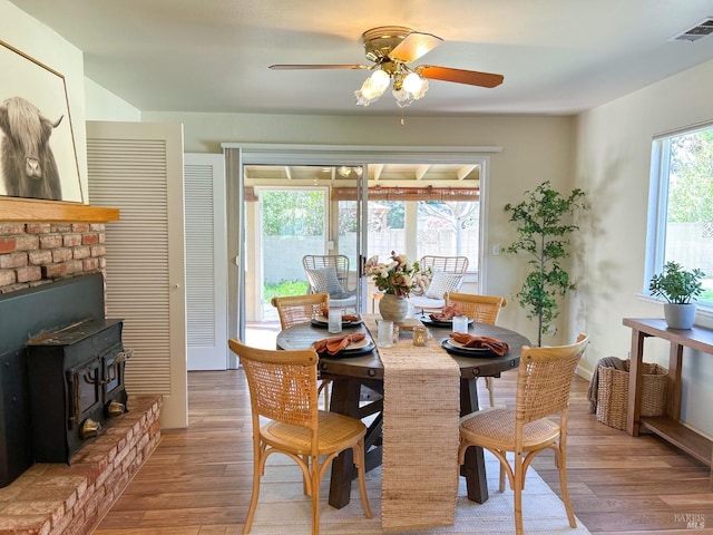 dining room with a wealth of natural light, light wood-style floors, and visible vents