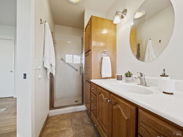 bathroom featuring vanity, tile patterned flooring, and a shower stall