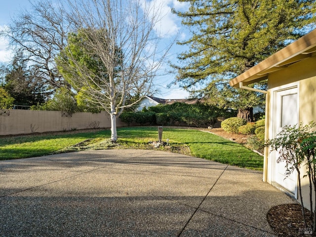 view of yard with fence and a patio area