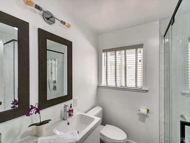 bathroom with vanity, a shower with shower door, and toilet