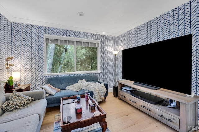 living room featuring ornamental molding and light wood-type flooring