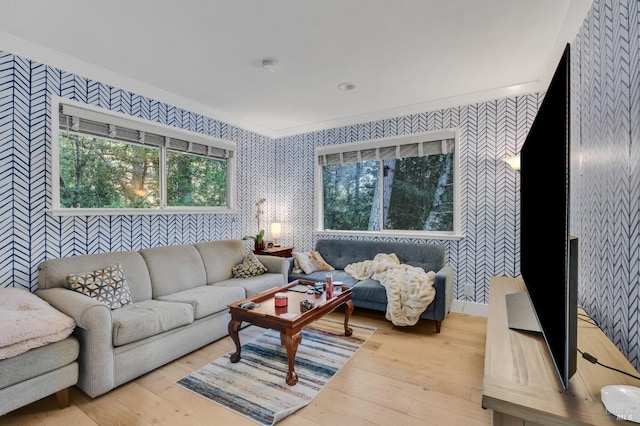 living room with ornamental molding and light wood-type flooring