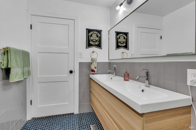 bathroom with vanity and tile walls