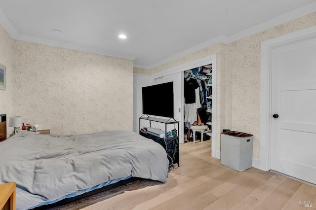 bedroom with crown molding and light hardwood / wood-style floors