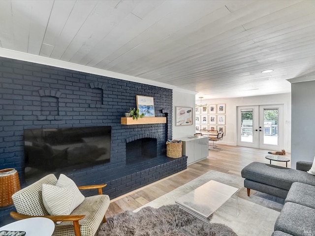 living room featuring light wood-type flooring, wooden ceiling, a fireplace, and french doors