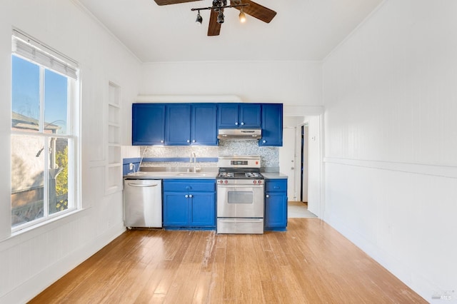 kitchen featuring blue cabinetry, appliances with stainless steel finishes, sink, and decorative backsplash