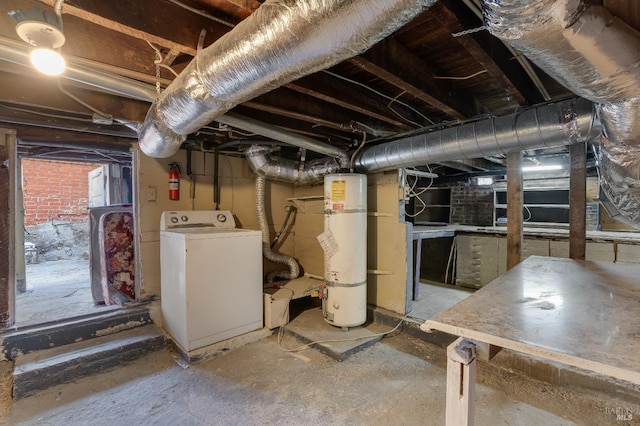 basement with strapped water heater and washer / dryer