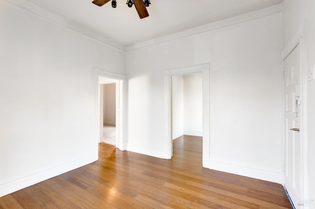 empty room featuring crown molding, ceiling fan, and light hardwood / wood-style flooring