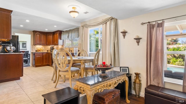 dining room with light tile patterned floors and plenty of natural light