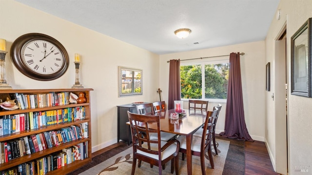 dining area with dark hardwood / wood-style floors