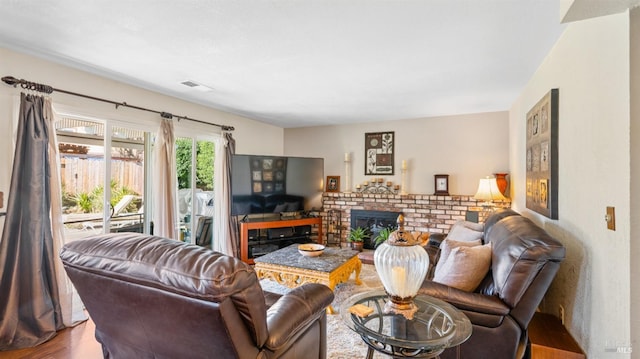 living room with a fireplace and hardwood / wood-style floors