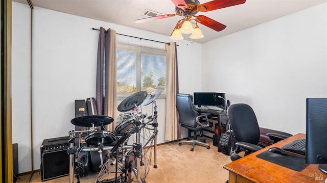 carpeted office featuring ceiling fan