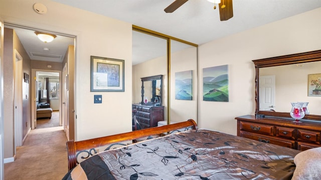 carpeted bedroom with ceiling fan and a closet