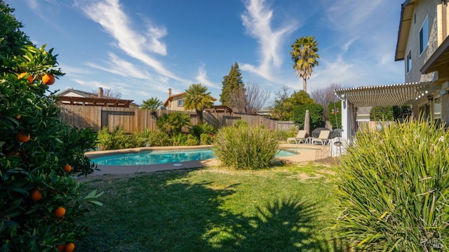 view of yard with a fenced in pool and a pergola