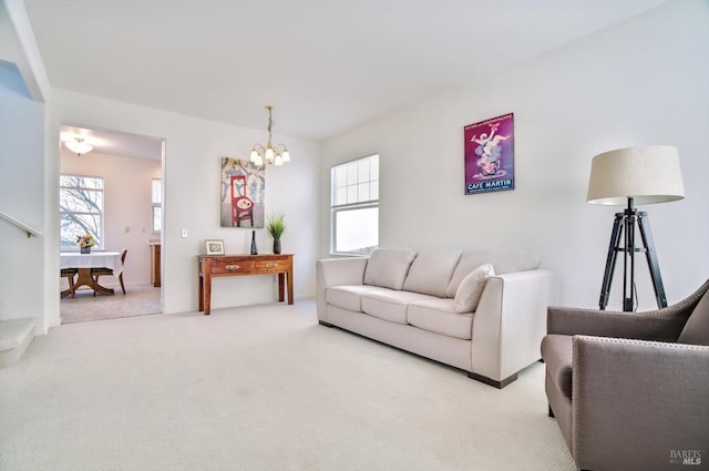 carpeted living room with a notable chandelier and a wealth of natural light