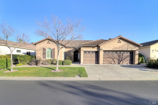 mediterranean / spanish-style home with a garage and a front yard