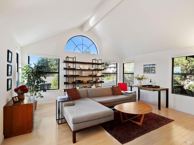 living room with beam ceiling, high vaulted ceiling, and light wood-type flooring