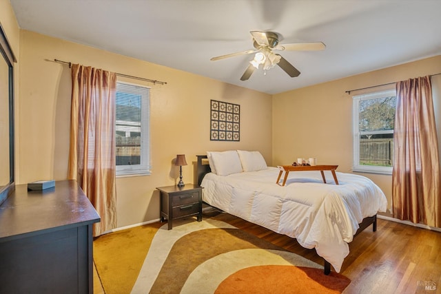 bedroom with hardwood / wood-style flooring and ceiling fan