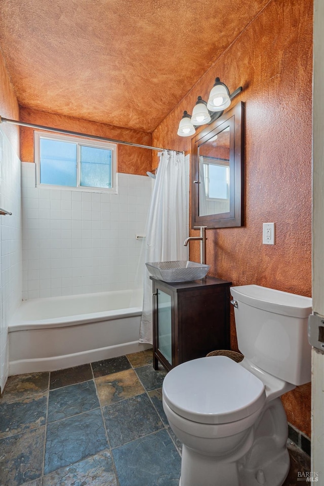 bathroom with shower / bathtub combination with curtain and toilet