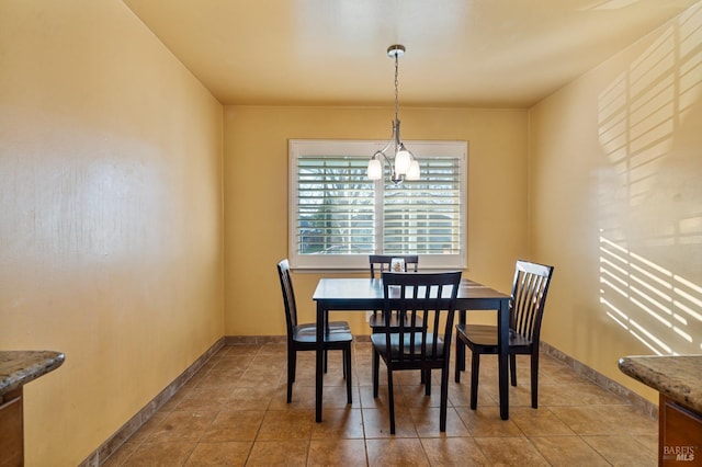 tiled dining space featuring a notable chandelier