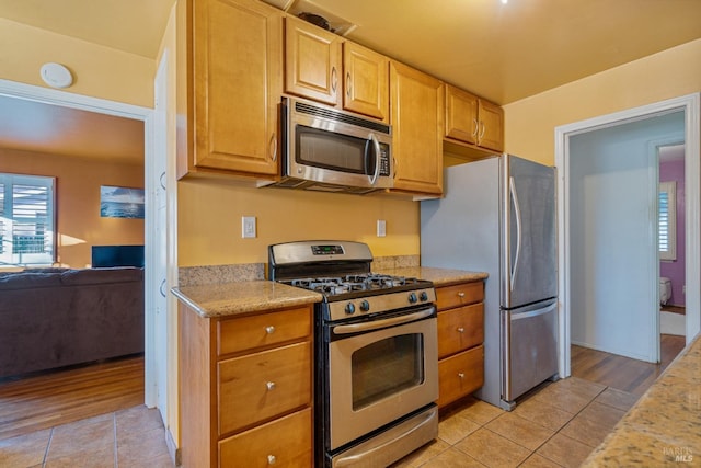 kitchen featuring appliances with stainless steel finishes and light tile patterned floors