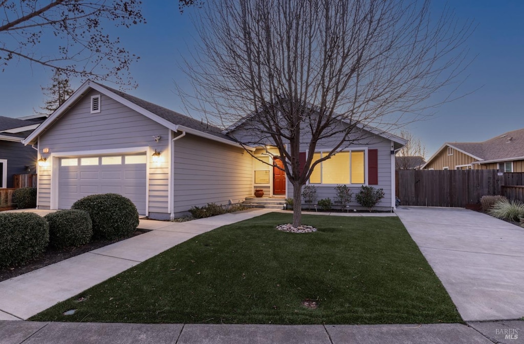 ranch-style home featuring a yard and a garage