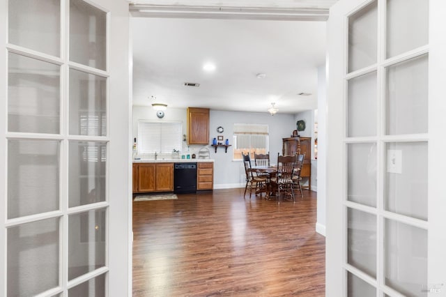 kitchen with black dishwasher, sink, dark hardwood / wood-style flooring, and french doors