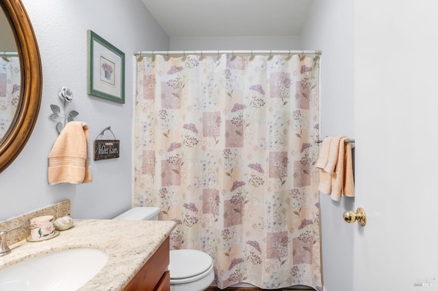 bathroom featuring vanity, a shower with curtain, and toilet