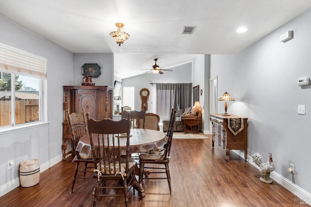 dining space featuring lofted ceiling, dark wood-type flooring, and ceiling fan