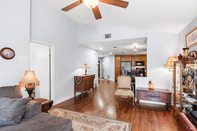 living room with dark wood-type flooring, ceiling fan, and lofted ceiling