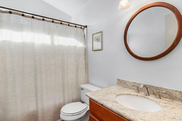 bathroom with vanity, lofted ceiling, a shower with shower curtain, and toilet