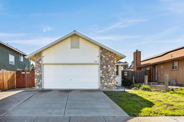 ranch-style home with a garage and a front lawn