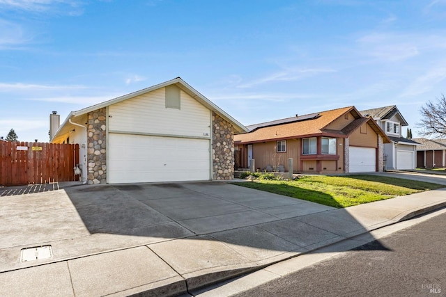 single story home with a garage and a front lawn