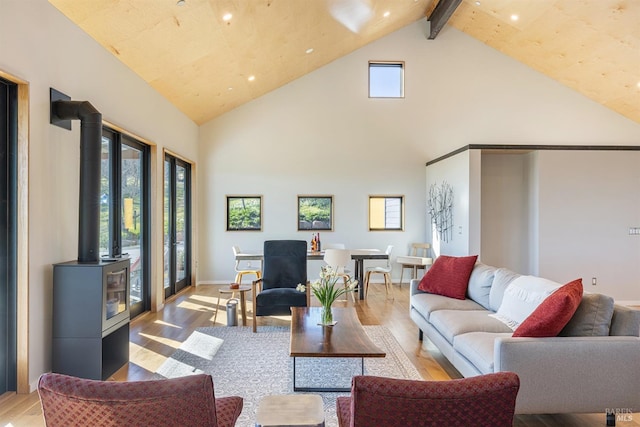 living room with beam ceiling, light hardwood / wood-style floors, and high vaulted ceiling