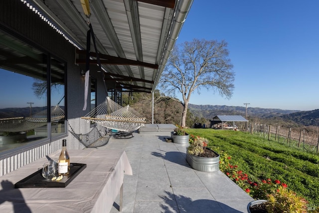 view of patio / terrace featuring a mountain view