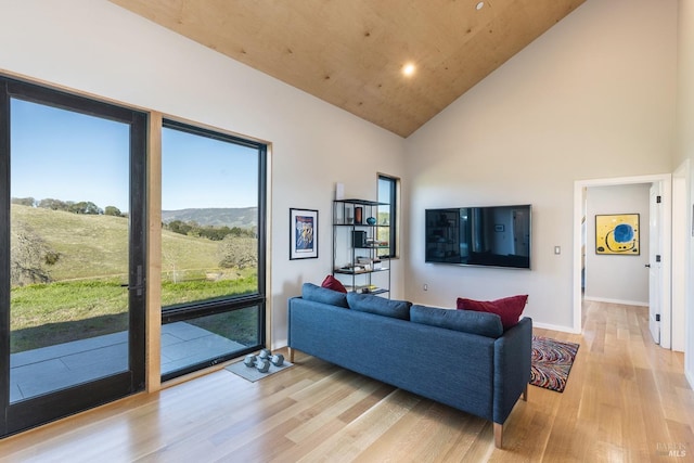 living room with light hardwood / wood-style flooring, high vaulted ceiling, and wooden ceiling