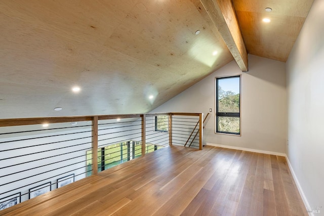 bonus room featuring hardwood / wood-style flooring and lofted ceiling with beams